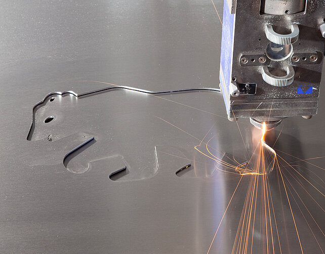 Auf dem Bild ist das Markenzeichen der Berndorf AG, ein Bär - mit Laser graviert - zu sehen.